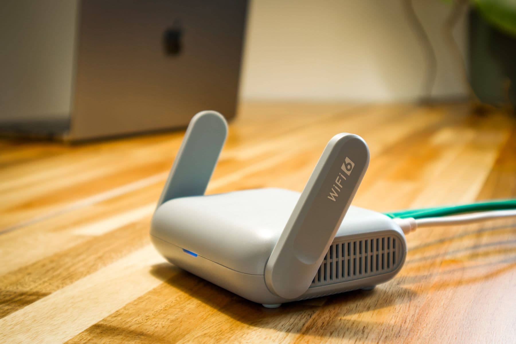 Wi-Fi 6 router on a desk — illustrative of a wireless last-mile path